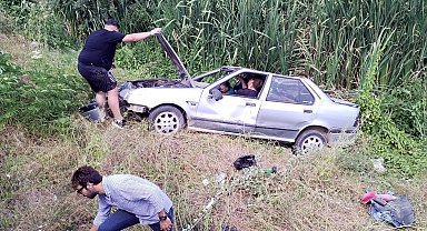 Dere yatağına devrilen otomobildeki 2 kişi yaralandı