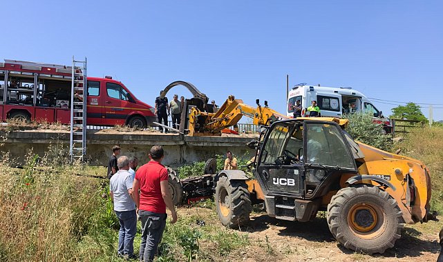 Köprüden düşen traktörün altında kalan sürücü iş makinesiyle kurtarıldı