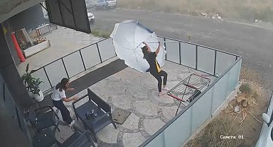 Şiddetli rüzgarda havalanan şemsiyeyle savruldular